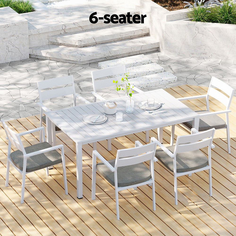 Outdoor dining set with 6-seater capacity on a wooden deck.