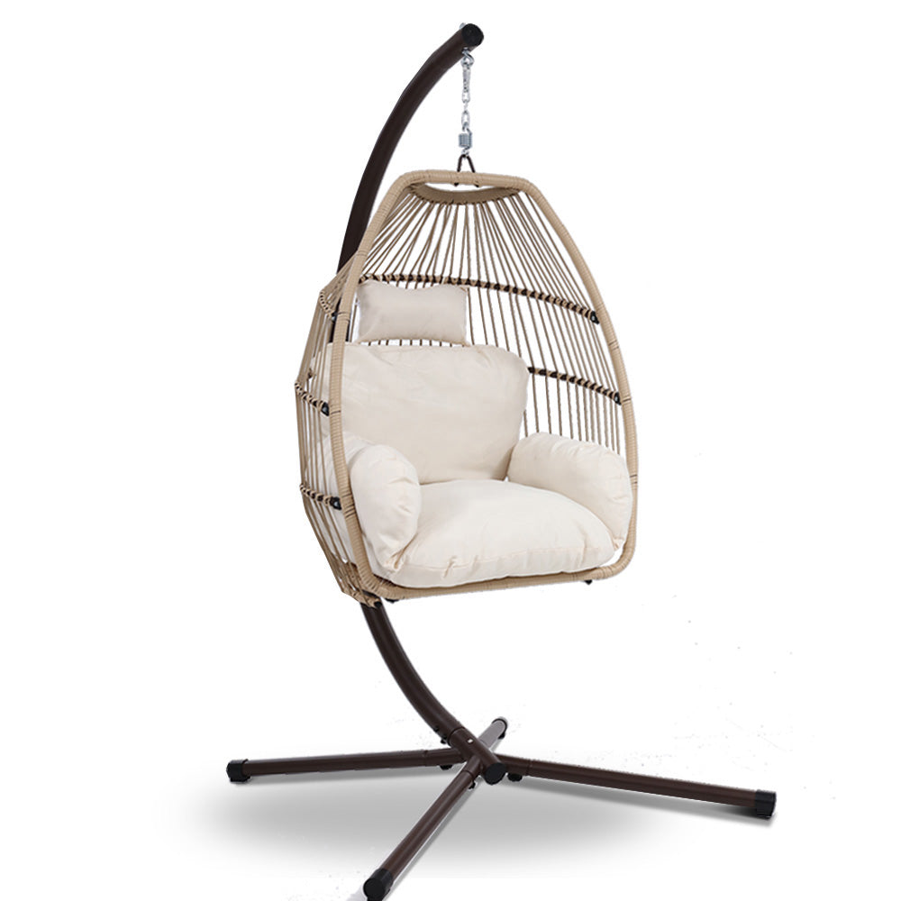 Hanging chair with white cushions on a stand against a white background