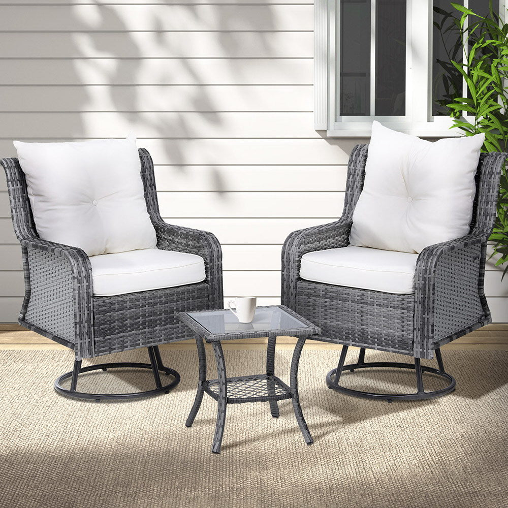 Outdoor patio set with two chairs and a table on a patio.