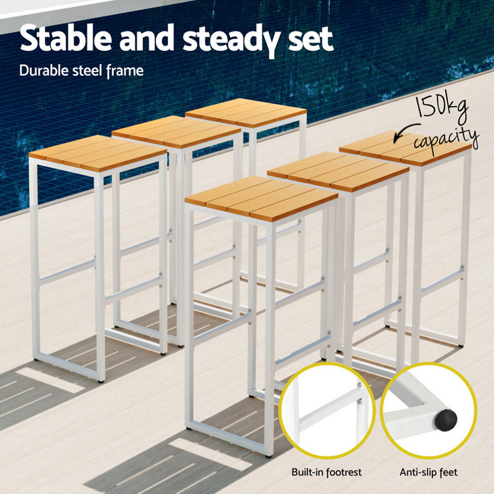 Set of four wooden stools with metal frames on a patio, highlighting stability and durability.