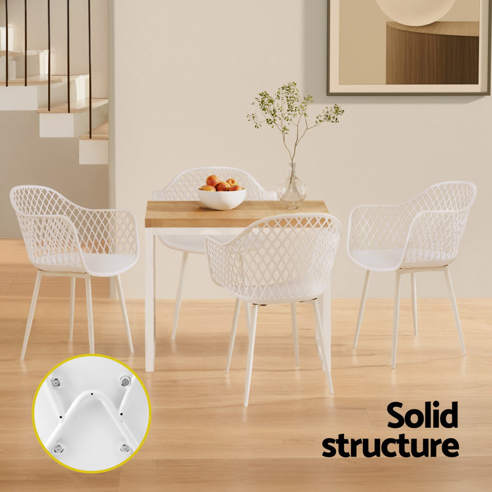 Dining room with wooden table and white chairs, featuring a close-up of chair base.