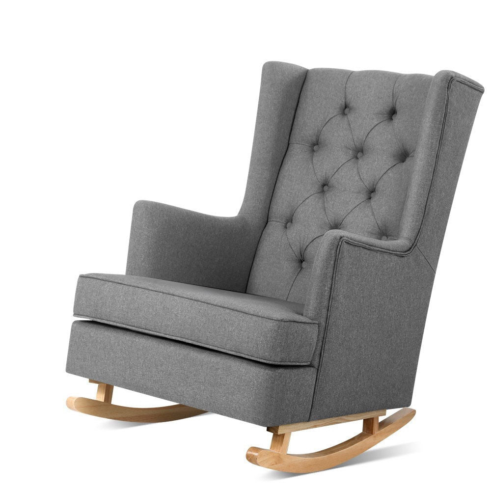 Gray upholstered rocking chair with tufted backrest on a white background