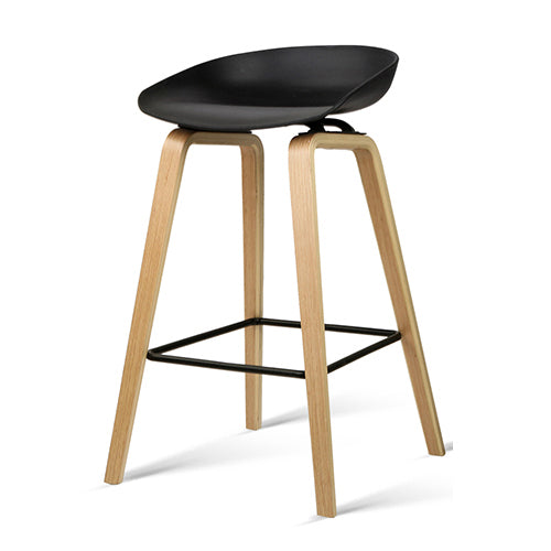 Bar stool with black seat and wooden legs on a white background