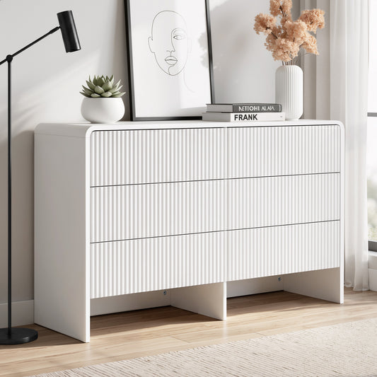 White dresser with decorative items in a room setting