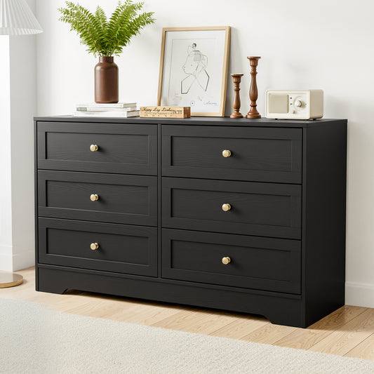 Black dresser with decorative items on top in a room setting