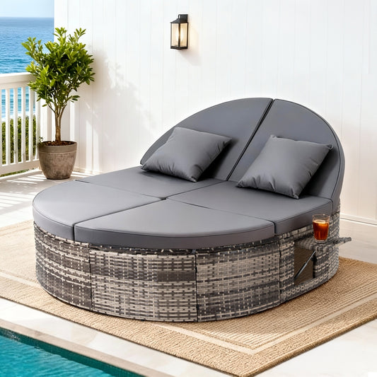 Round outdoor lounge chair with cushions on a patio with ocean view