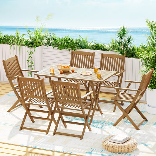 Outdoor dining set with table and chairs on a patio with ocean view