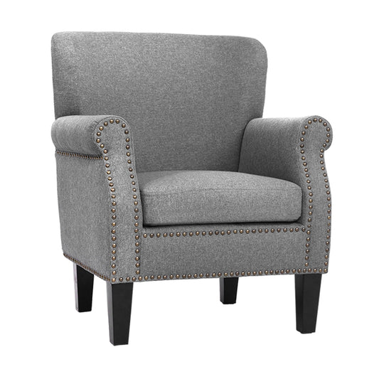 Gray armchair with nailhead trim on a white background